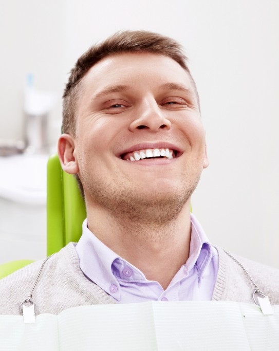 Man grinning in dental chair