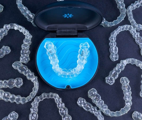 Several Invisalign clear aligners on a table