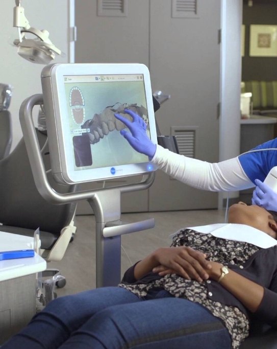 Dentist showing a patient digital scans of their teeth