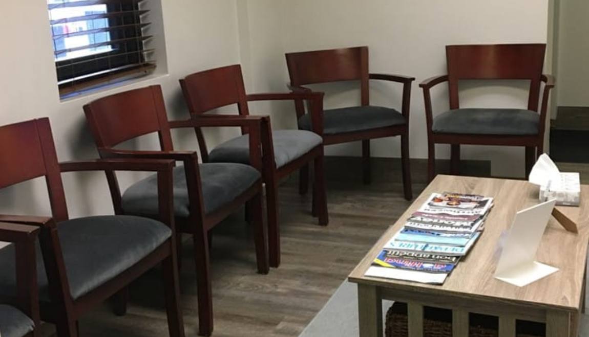 Wooden chairs in reception area of Gramercy Dental Studio