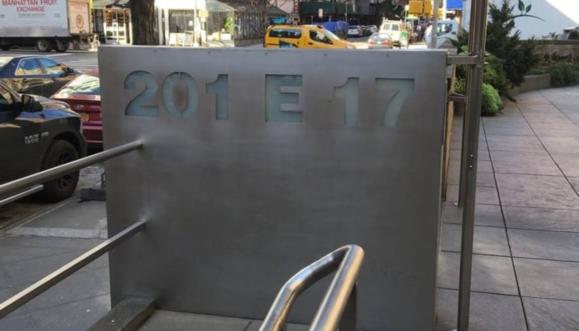 Sign outside of building that reads 201 E 17
