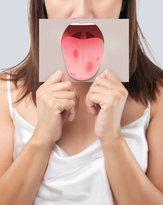 Woman holding drawing of open mouth in front of her face