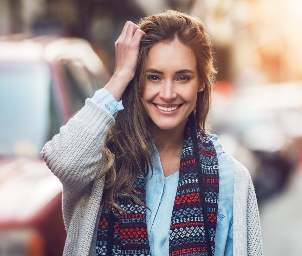 Woman in scarf smiling on New York city street