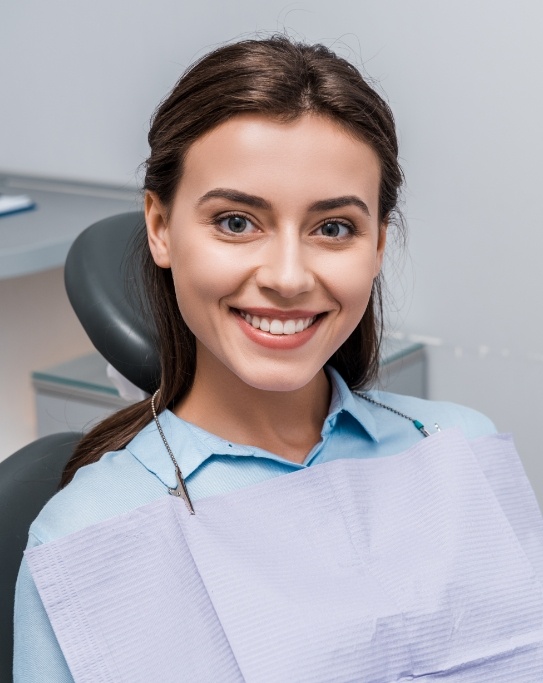 Smiling young woman sitting in dental chair