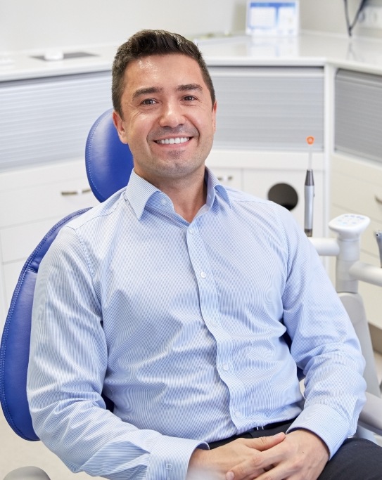 Smiling man sitting in dental chair