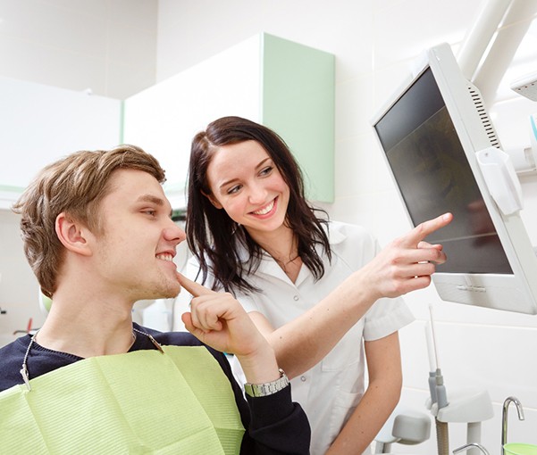 Dentist and patient looking at computer monitor together