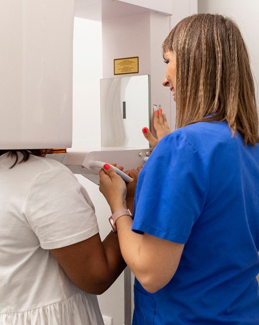 Dental team member prepping patient for CBCT scan