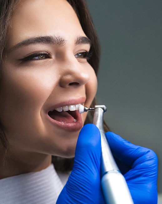 Dentist cleaning a patient’s teeth