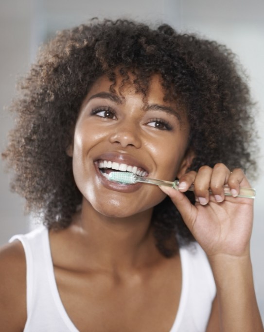 A woman smiling at her dental appointment.