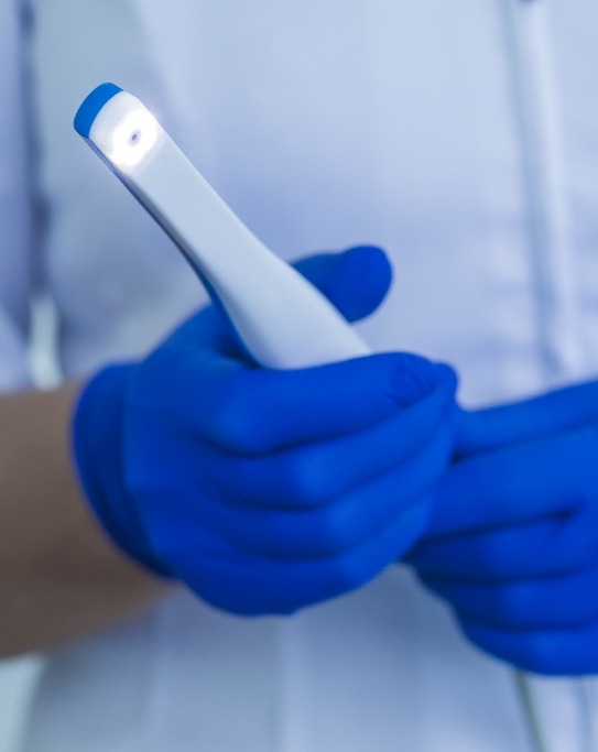 Dental professional holding an intraoral camera pen