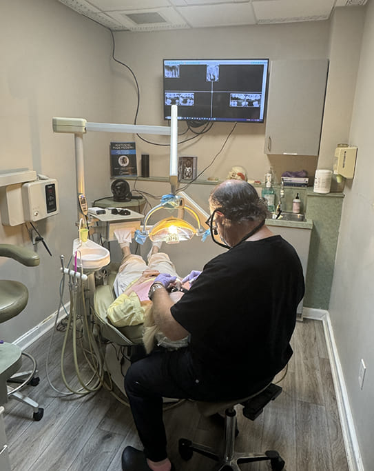 Woman holding her cheek in pain while visiting emergency dentist