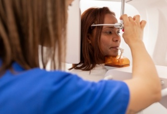 Woman getting a cone beam scan of her mouth and jaw