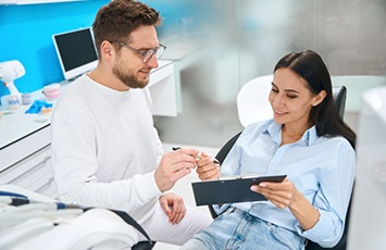 Dental patient signing paperwork