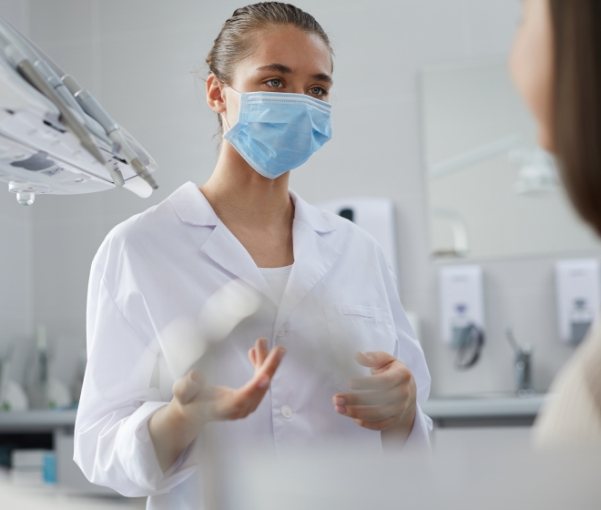 New York dental team member talking to a patient