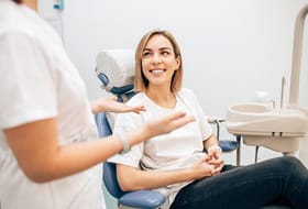 A dentist speaking to a patient.