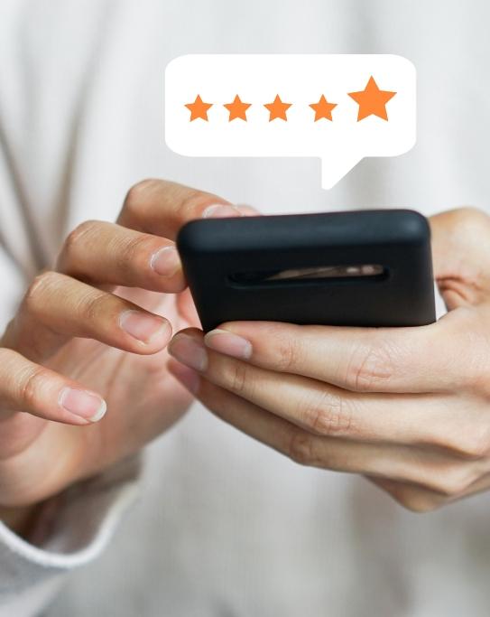 Person leaving a five star review on their phone