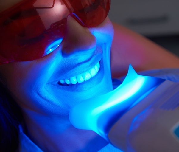 Woman getting professional teeth whitening in New York dental office