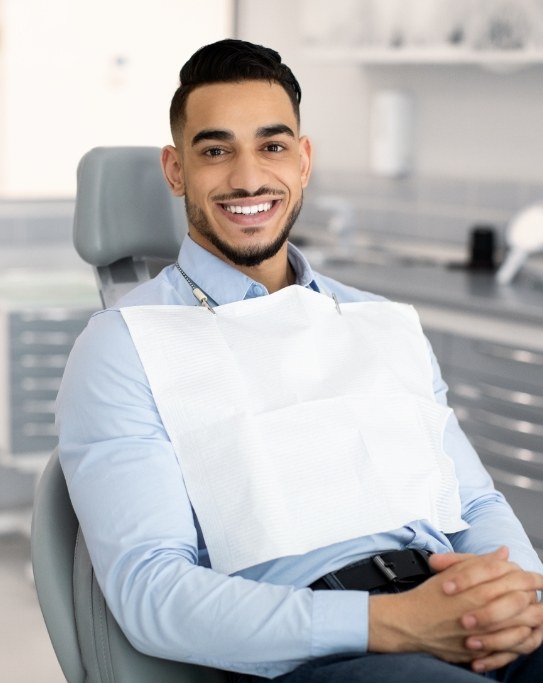 Smiling man sitting in dental chair