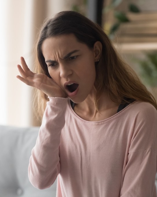 Woman holding the side of her jaw in pain