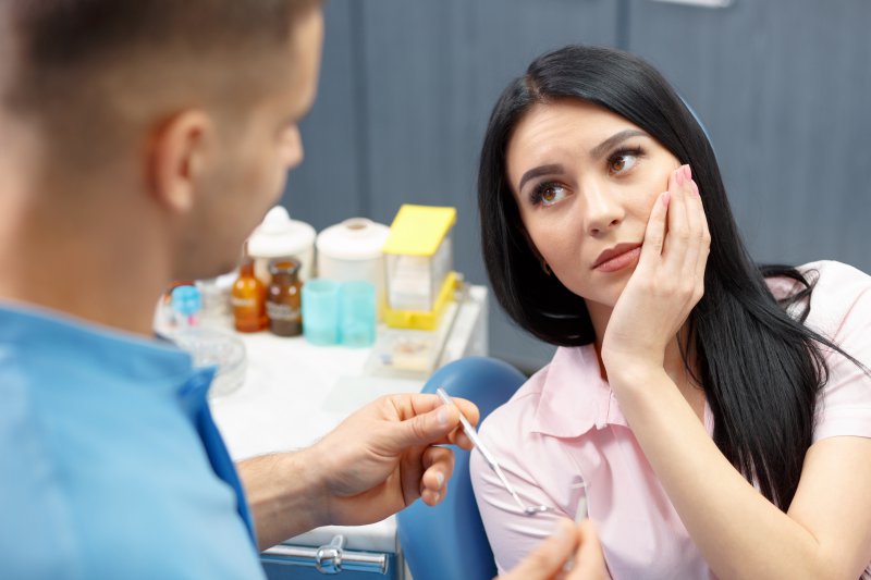 Patient discussing migraines and TMJ in Gramercy Park with dentist.