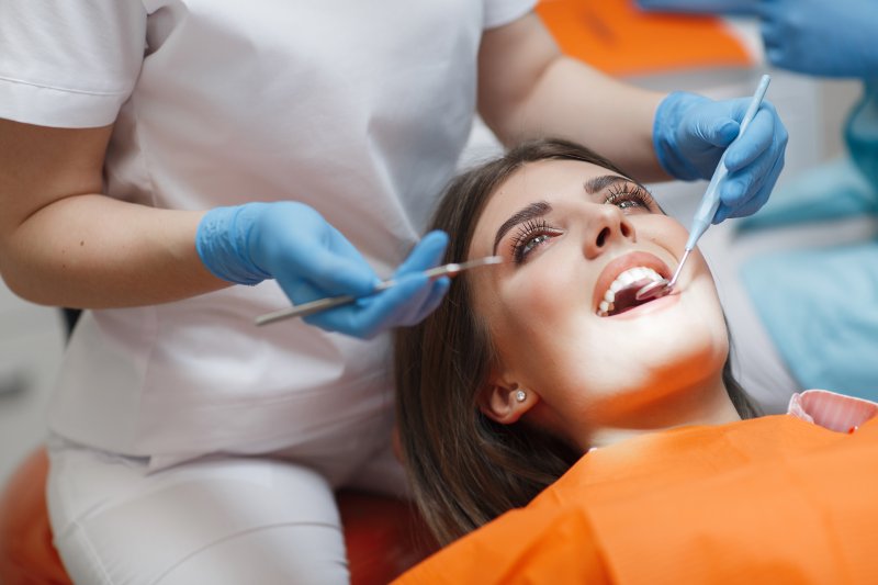 dentist looking at patient’s mouth