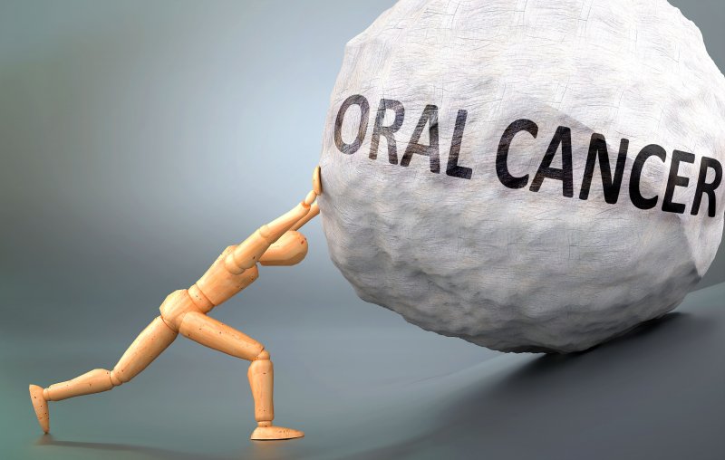 wooden man stopping “oral cancer” rock in New York