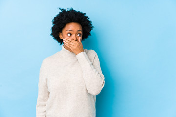 person with a loose tooth covering their mouth