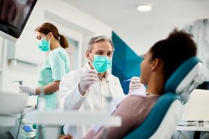 a woman happily attending her dental checkup at the beginning of the new year