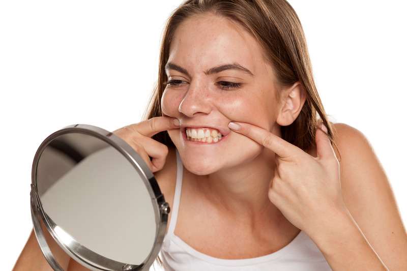 Patient checking smile after getting teeth whitening