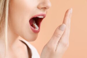 woman smelling her fresh breath
