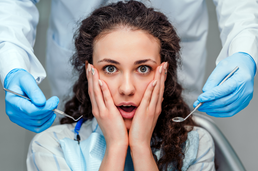 Patient in dental chair looking scared