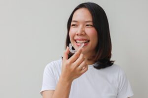 Woman putting on her retainer 