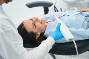 Dentist using an intraoral camera on a female patient